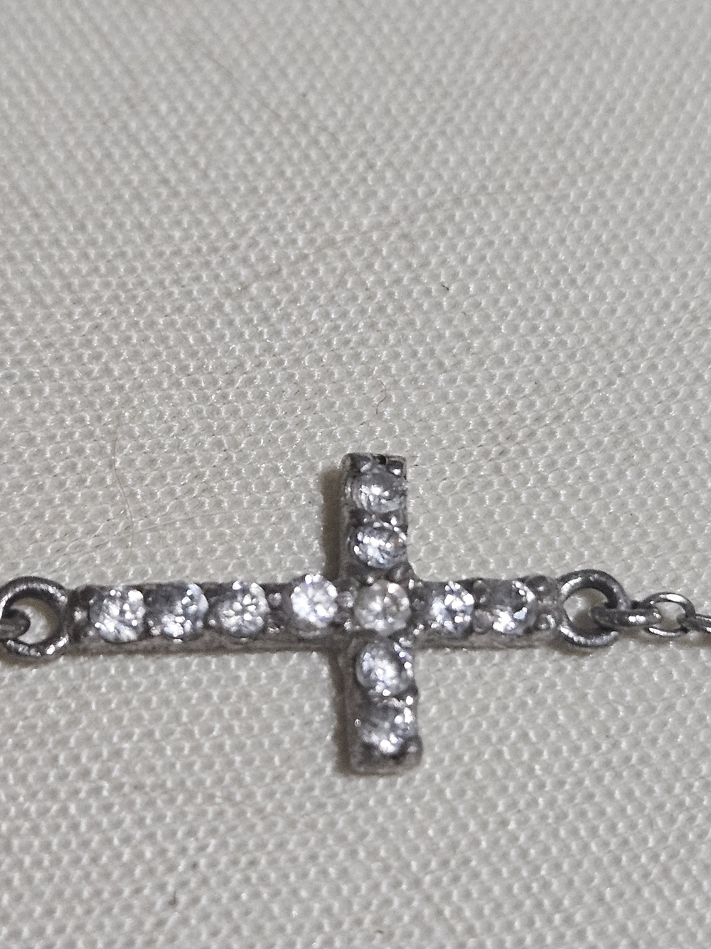 Rhinestone-accented sideways Cross & an Oval Charm stamped with the word "Faith